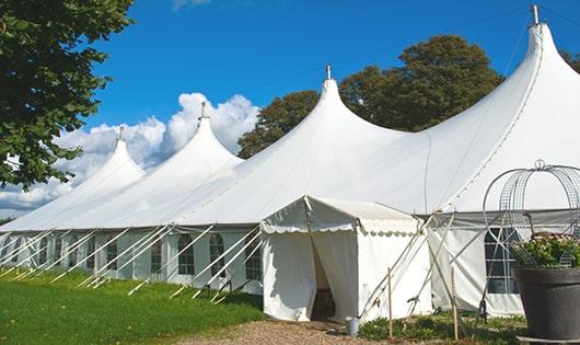 a line of portable restrooms in a shaded area, offering a comfortable experience for users in Elsah